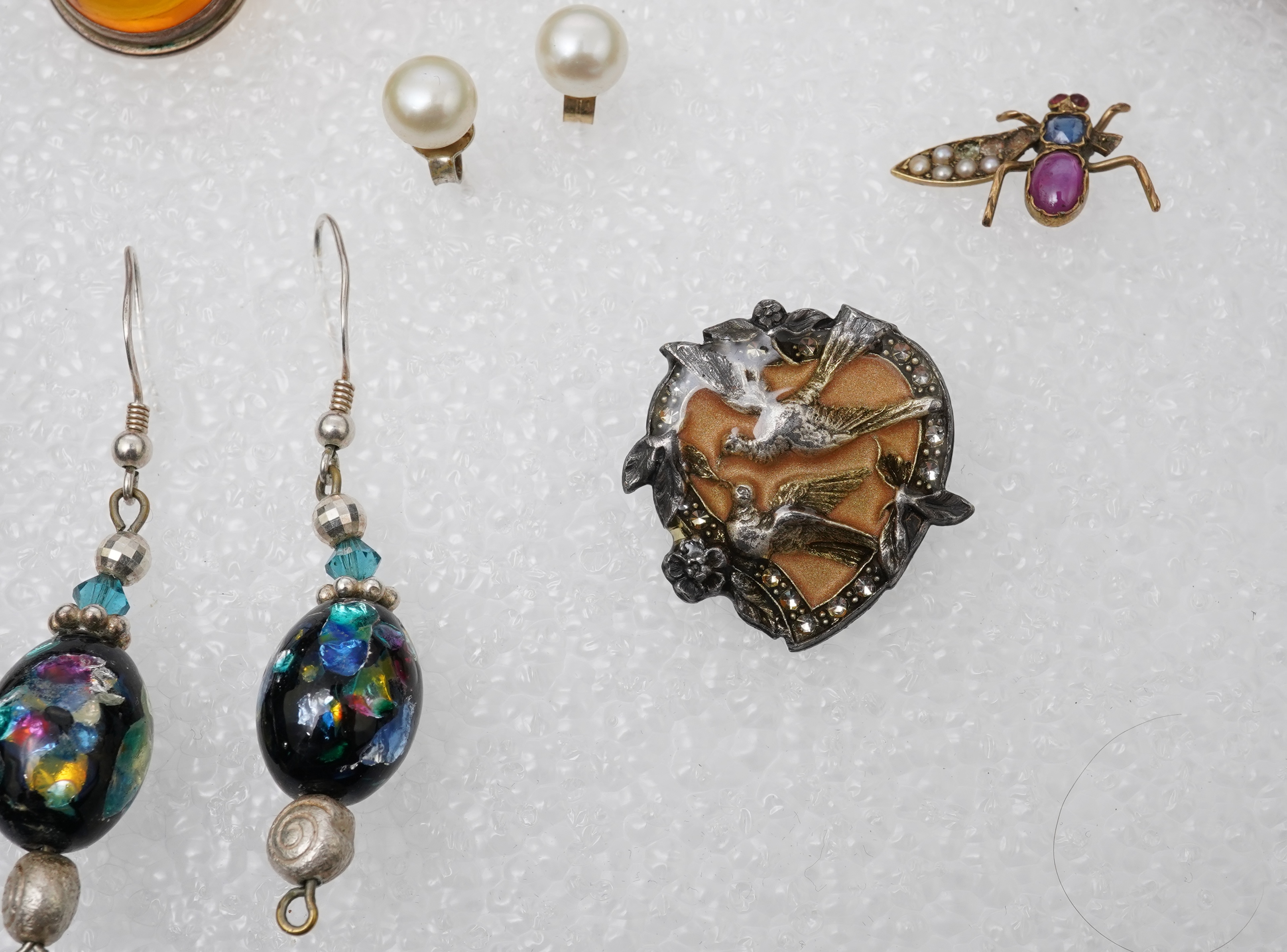 A small collection of costume jewellery to include a silver curb link charm bracelet, hung with assorted bezel set agate and carnelian drops, together with other silver and costume jewellery